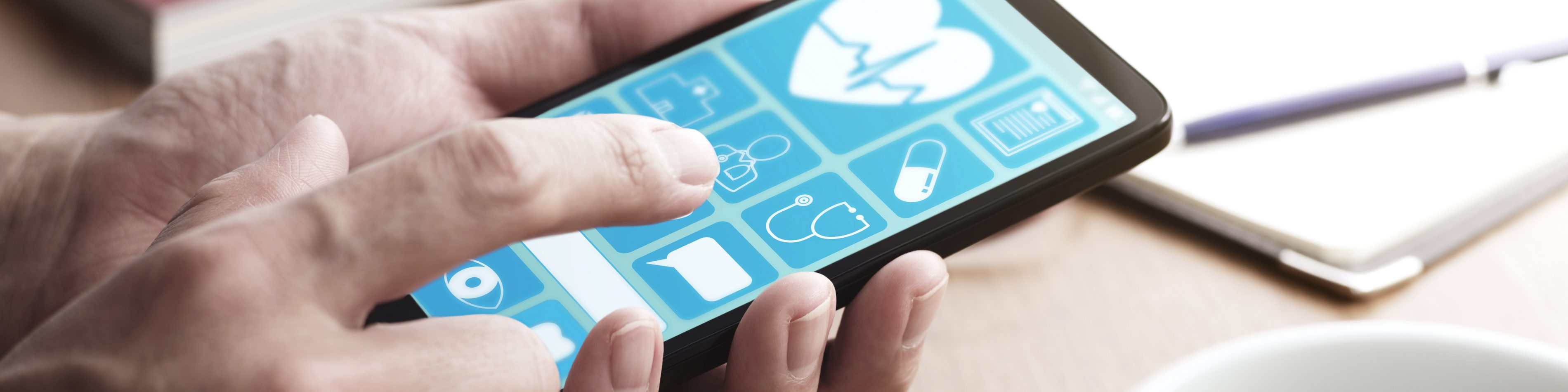 Online healthcare app on smartphone screen. | VIACTIV Krankenkasse