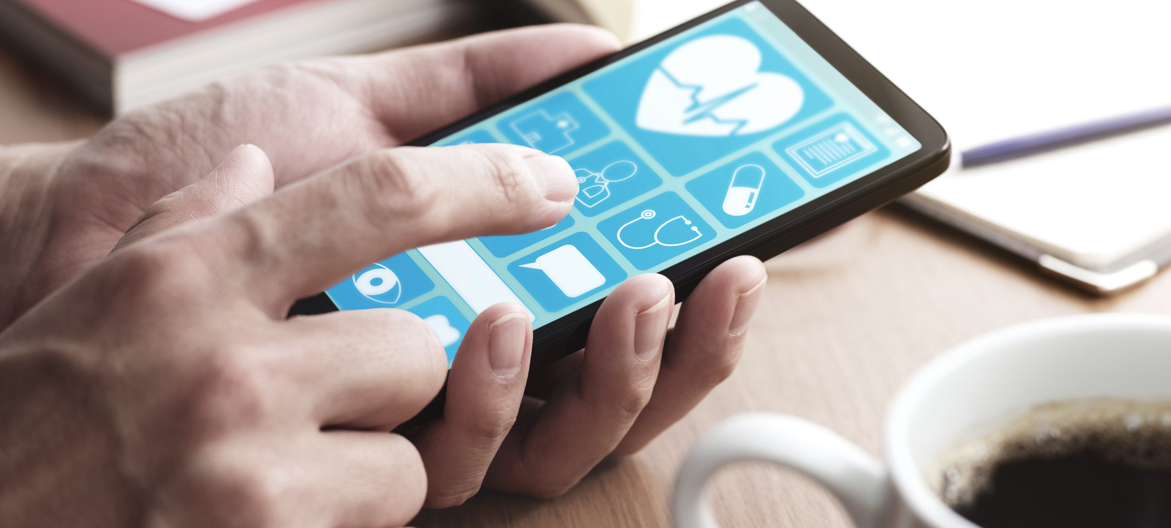 Online healthcare app on smartphone screen. | VIACTIV Krankenkasse