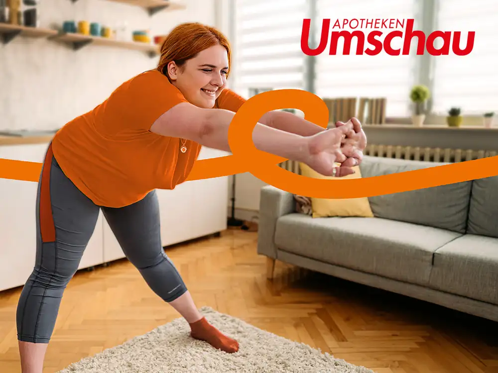 Eine Frau steht in der Küche und macht Dehnübungen. | VIACTIV Krankenkasse
