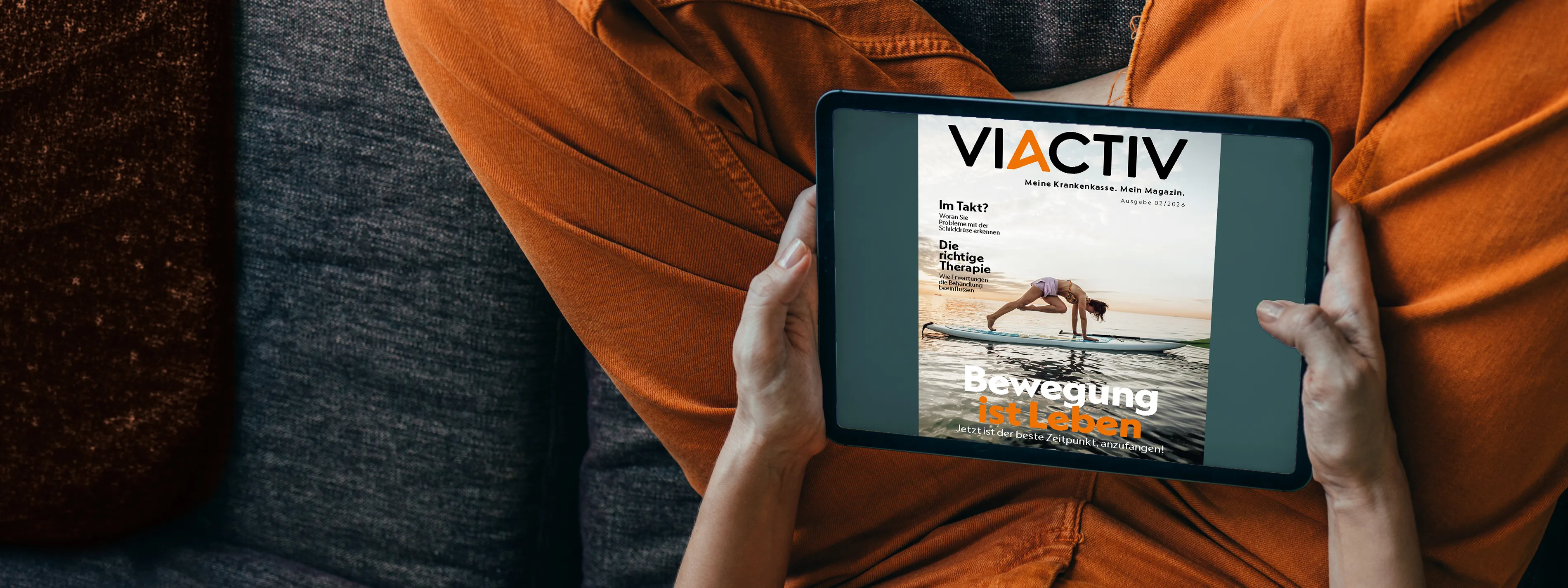 Jemand hält ein Tablet in der Hand. Auf dem Display ist die Sommerausgabe des VIACTIV Magazins 2026 abgebildet. | VIACTIV Krankenkasse